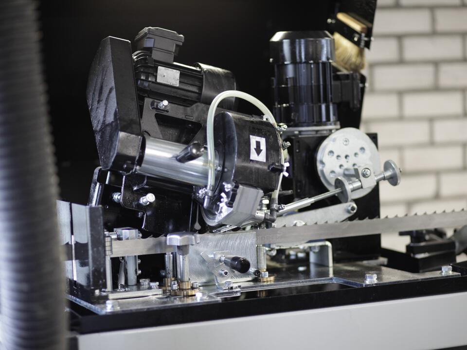 A bandsaw being sharpened on a machine.