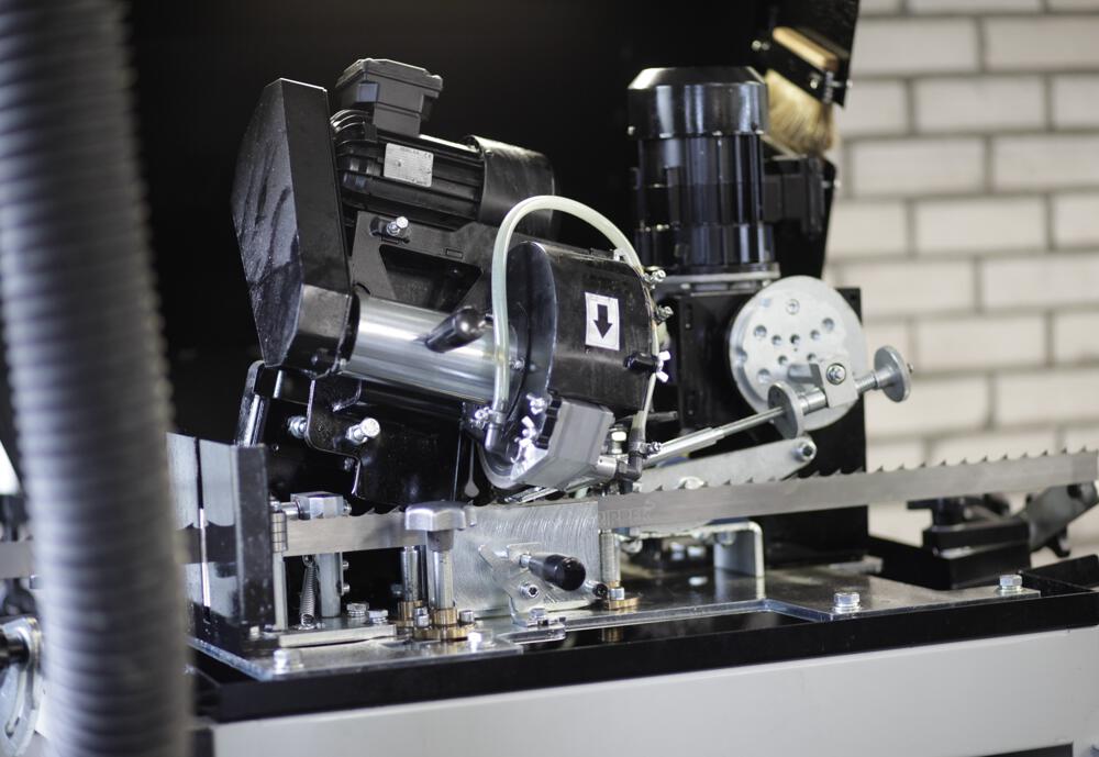 A bandsaw being sharpened on a machine.